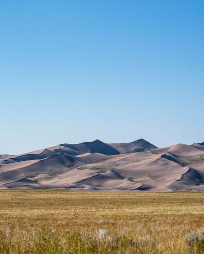 A vertical shot of a national park with sand dunes in the USA on a bright sunny day