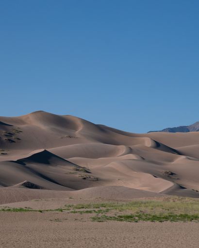 A vertical shot of a national park with sand dunes in the USA on a bright sunny day