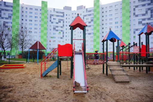 Slide equipment with small child on a playground