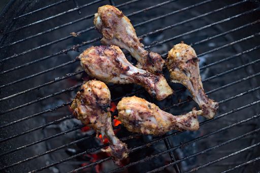 An overhead shot of chicken legs cooking on the grill