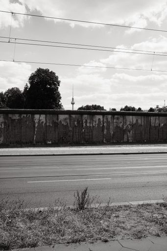 A vertical shot of the old Berlin Wall with Berlin TV Tower Alex in Germany