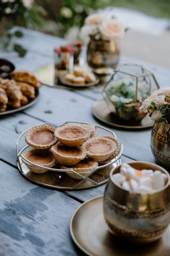 A vertical shot of a butter tart on a wooden table