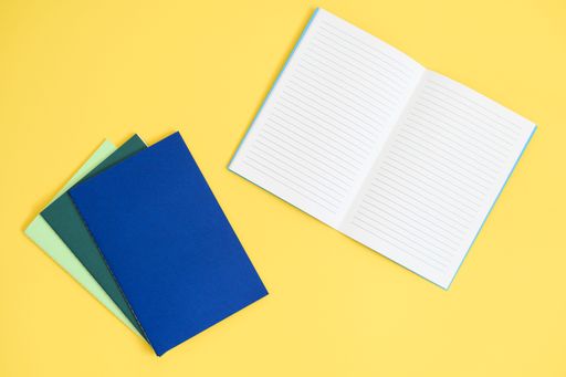 notebook on bright yellow background from above