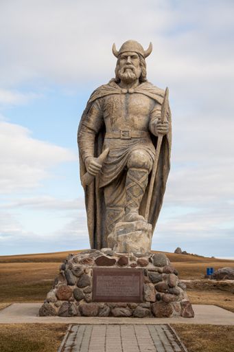 Vertical view of old Viking statue on waterfront of lake Winnipeg in Gimli, Manitoba, Canada under cloudy sky