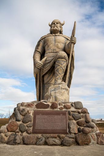 Vertical view of old Viking statue on waterfront of lake Winnipeg in Gimli, Manitoba, Canada under cloudy sky