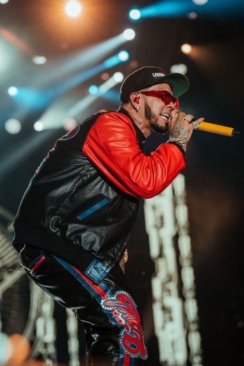 A vertical shot of rapper Anuel performing at a festival in Miami, United States