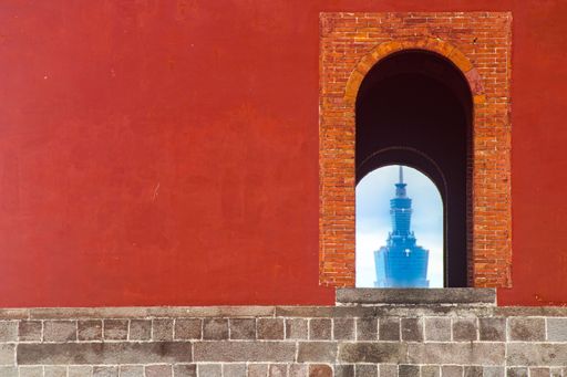 A beautiful view of the skyscraper seen through an old arch door in Taipei, Taiwan