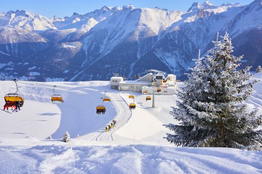 A ski lift over snowy hill in the Valais Alps