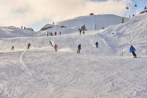 People skiing in the Valais Alps - a beautiful snowy landscape