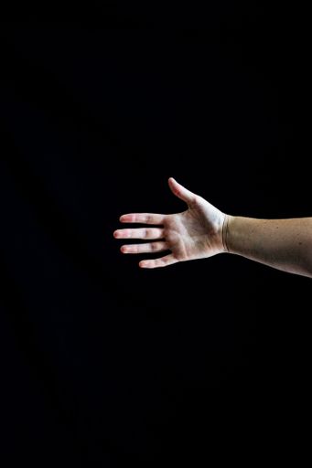 A vertical shot of a palm of a hand on the black background
