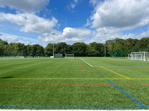 An artificial football field with colorful lines and nets
