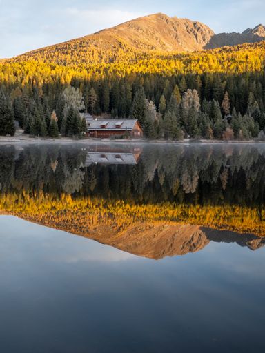 Mountainlaike Prebersee in the Austrian Alps at Sunset in the Morning with Fog and rich colors. Shot in the fall autumn with a bit of snow.