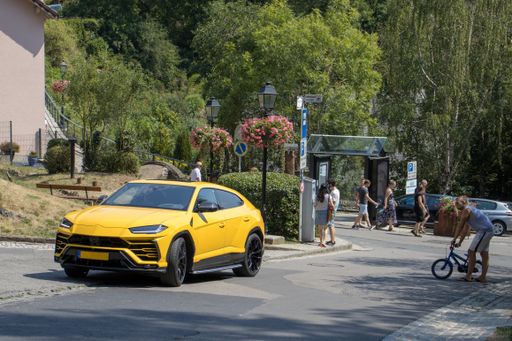 Lamborghini Urus at Vianden castle in Luxembourg on a hot day