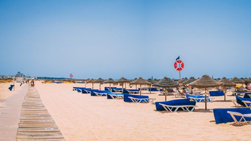View on the beautiful beach Praia da Falesia - Praia da Rocha Baixinha Nascente with beautiful red rocks and golden sand. Region Faro, Algarve