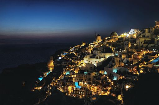 An aerial shot of Oia village in Santorini at night