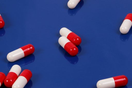 A closeup shot of medicine capsules  on a blue surface