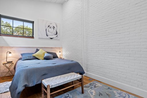 A beautiful shot of a modern bedroom with white brick walls