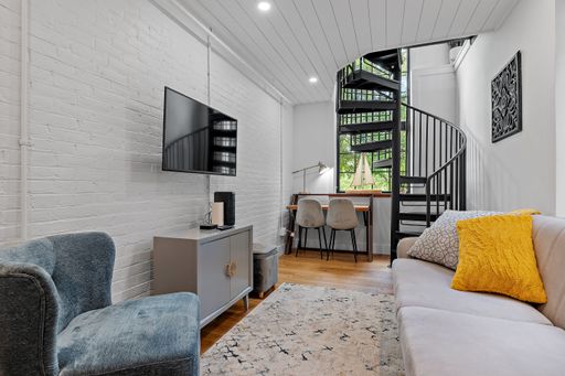 A beautiful shot of a modern living room with white brick walls