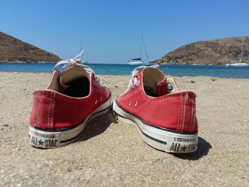 Red All star converse on the sand at Kithnos beach Colona