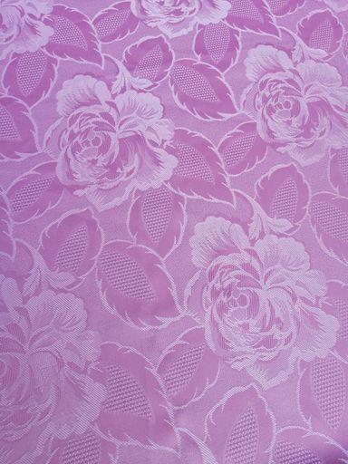 A vertical shot of pink tablecloth with roses