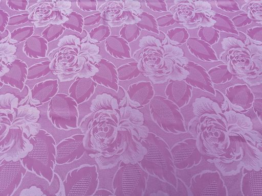 A closeup shot of pink tablecloth with roses