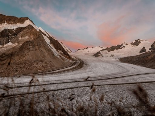 A beautiful shot of the snowy rocky mountains under an evening sky in Fieschertal, Switzerland
