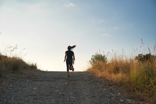A low angle shot of a female jogging in a park