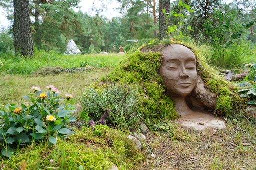 An artistic statue of a mother Earth made of created from local natural materials