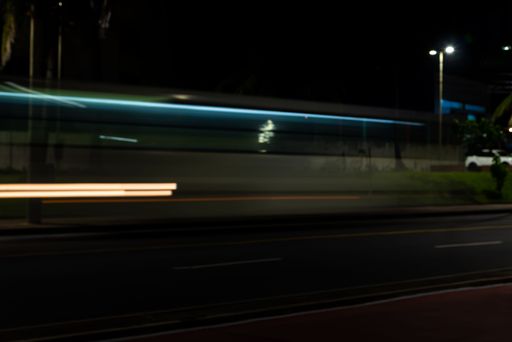 A colorful light trail with the motion blur effect of a bus