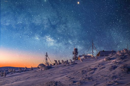 A landscape with constructions and blue starry night sky with the last notes of sunset orange colors