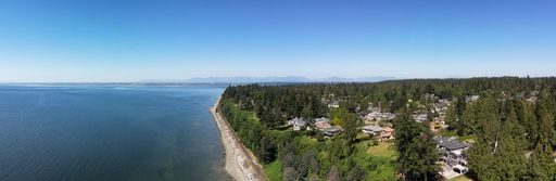 Aerial Panoramic View of Homes on a shore by the ocean. Sunny Summer. White Rock, Vancouver, BC, Canada.