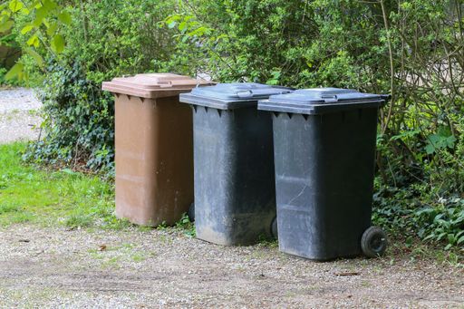 Three garbage cans on the street