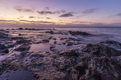 A beautiful scenery of huge rock formations near the sea under the breathtaking sunset sky
