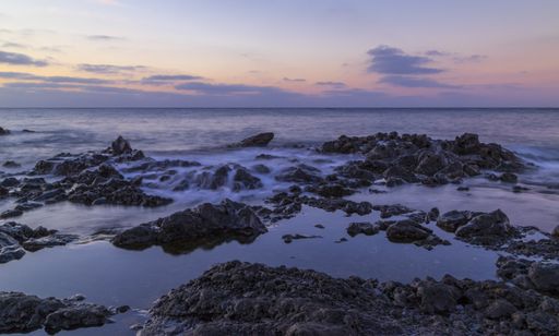 A beautiful scenery of huge rock formations near the sea under the breathtaking sunset sky