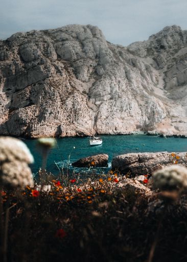 A boat in the sea near a rocky coast