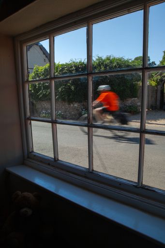 A vertical shot from the window of a cyclist in a driving motion