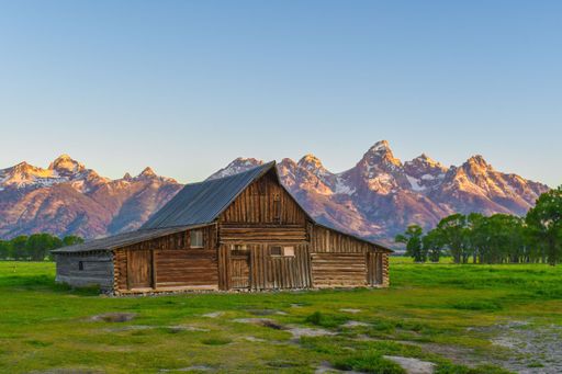 A mesmerizing view of a golden sunset over mountains and the cabin