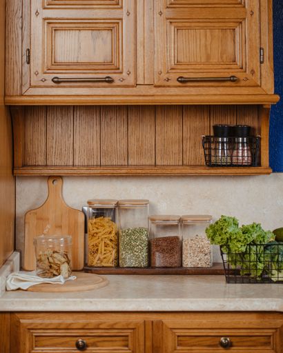A vertical shot of a kitchen countertop with spices and ingredients placed on top