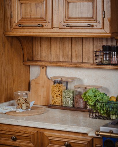 A vertical shot of a kitchen countertop with spices and ingredients placed on top