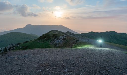 A person on dirt trail on Matagalls peak of the Montseny Massif, Catalonia, Spain during sunset