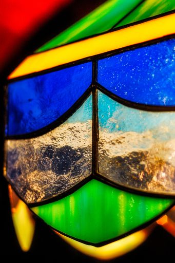 A vertical shot of stained glass with beautiful textures