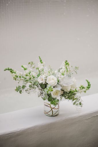 A vertical closeup shot of a beautiful bouquet in vase on a white background
