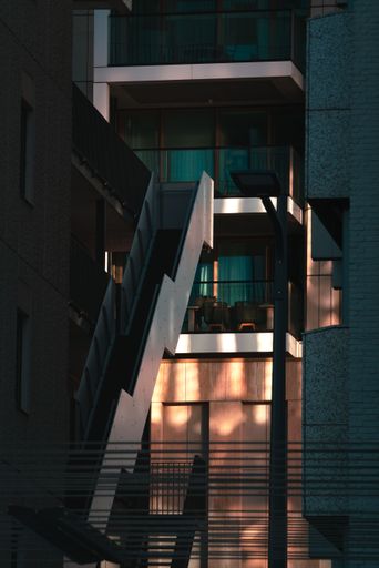 A vertical shot of a modern staircase in an illuminated business building