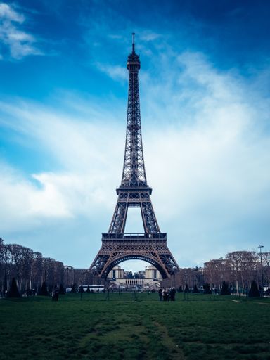 A beautiful vertical shot of the Eiffel Tower on a bright blue sky background
