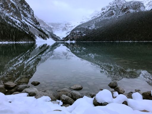 The snowy mountains reflecting in the lake.
