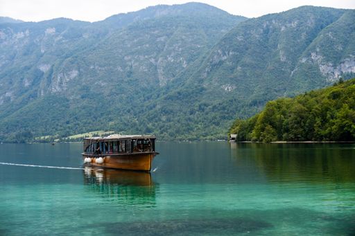 A wooden excursion boat on Lake Bohinj near the Julian Alps