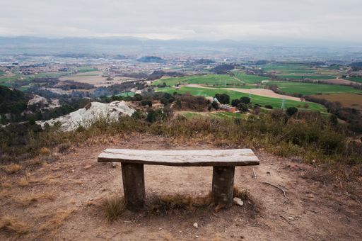 A beautiful shot of a bench on the hill