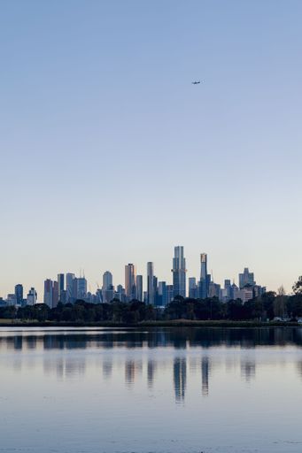 A vertical shot of the Melbourne city reflecting on the lake water