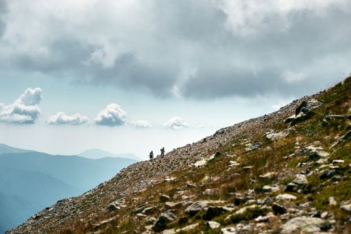A fantastic shot of hikers in the distance climbing a slope of a mountain in the French Riviera