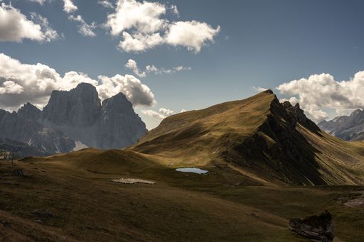 A beautiful scenery of the Mondeval plateau within the Dolomites Mountains under the cloudy blue sky